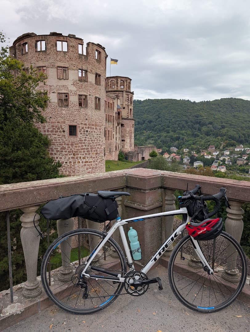Ahmet Ala's touring bike in front of Heidelberg Castle.